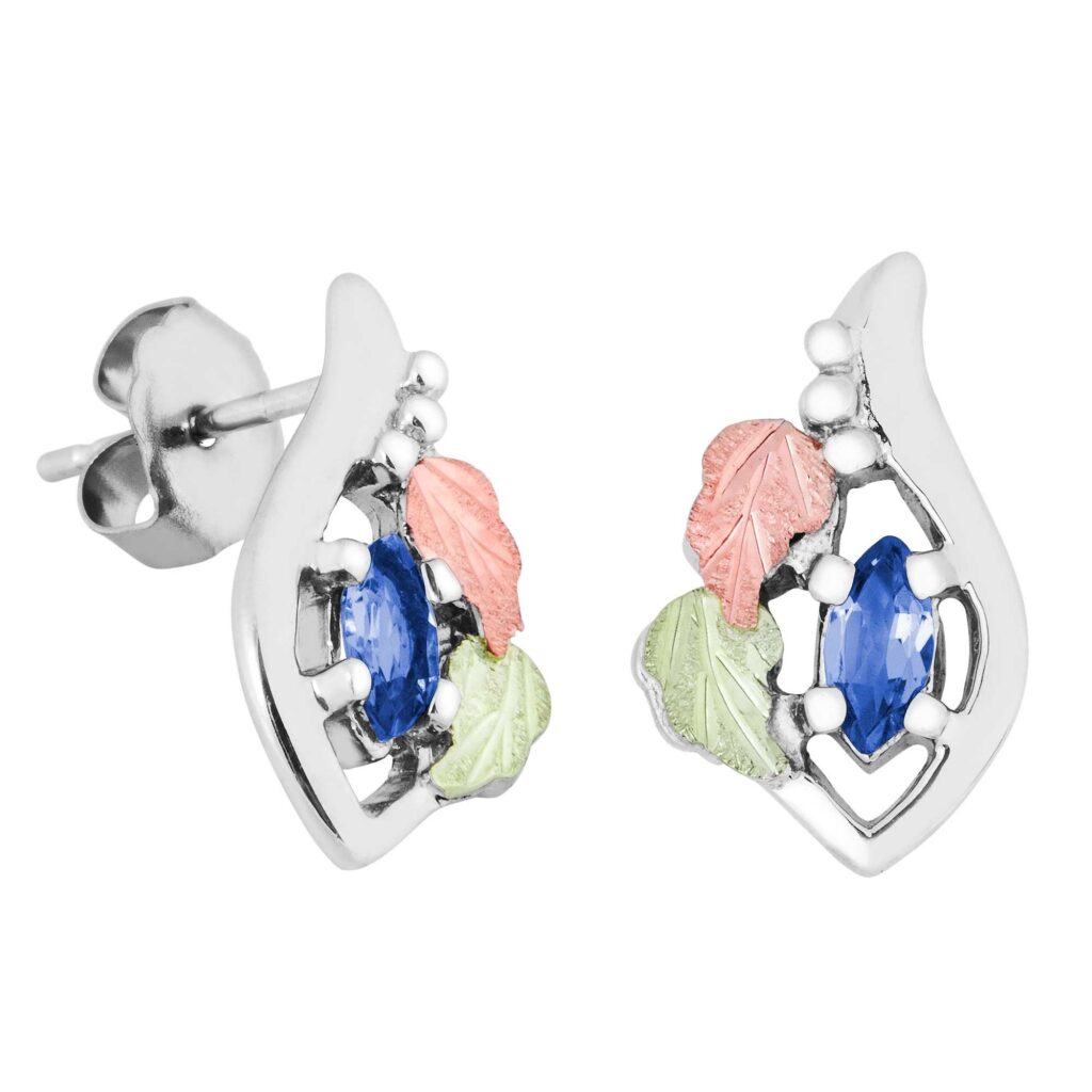 Pair of dental model jaws with metal braces and multicolored elastics on the teeth.